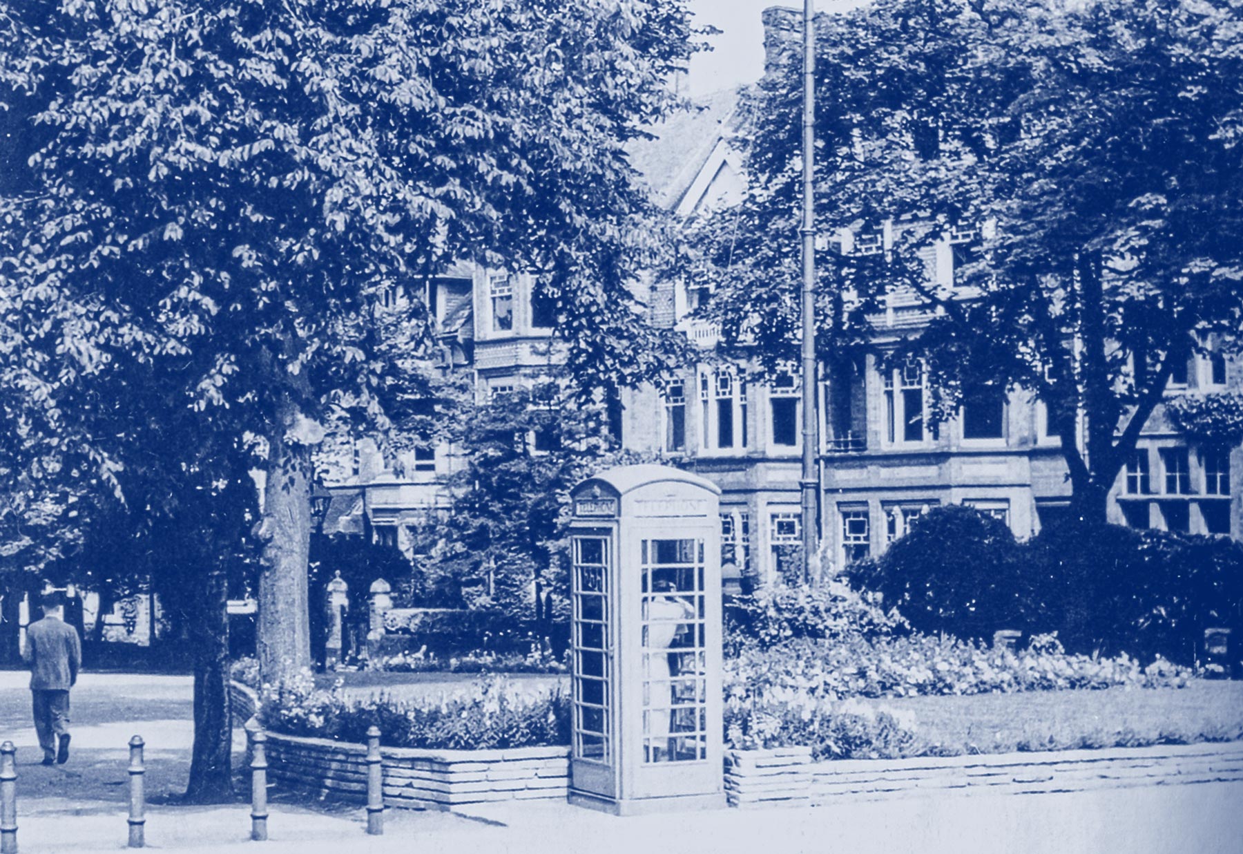 Photograph of the top of New Walk (1960s) showing the triangular garden, the iron tram standard and the telephone kiosk (no longer there)