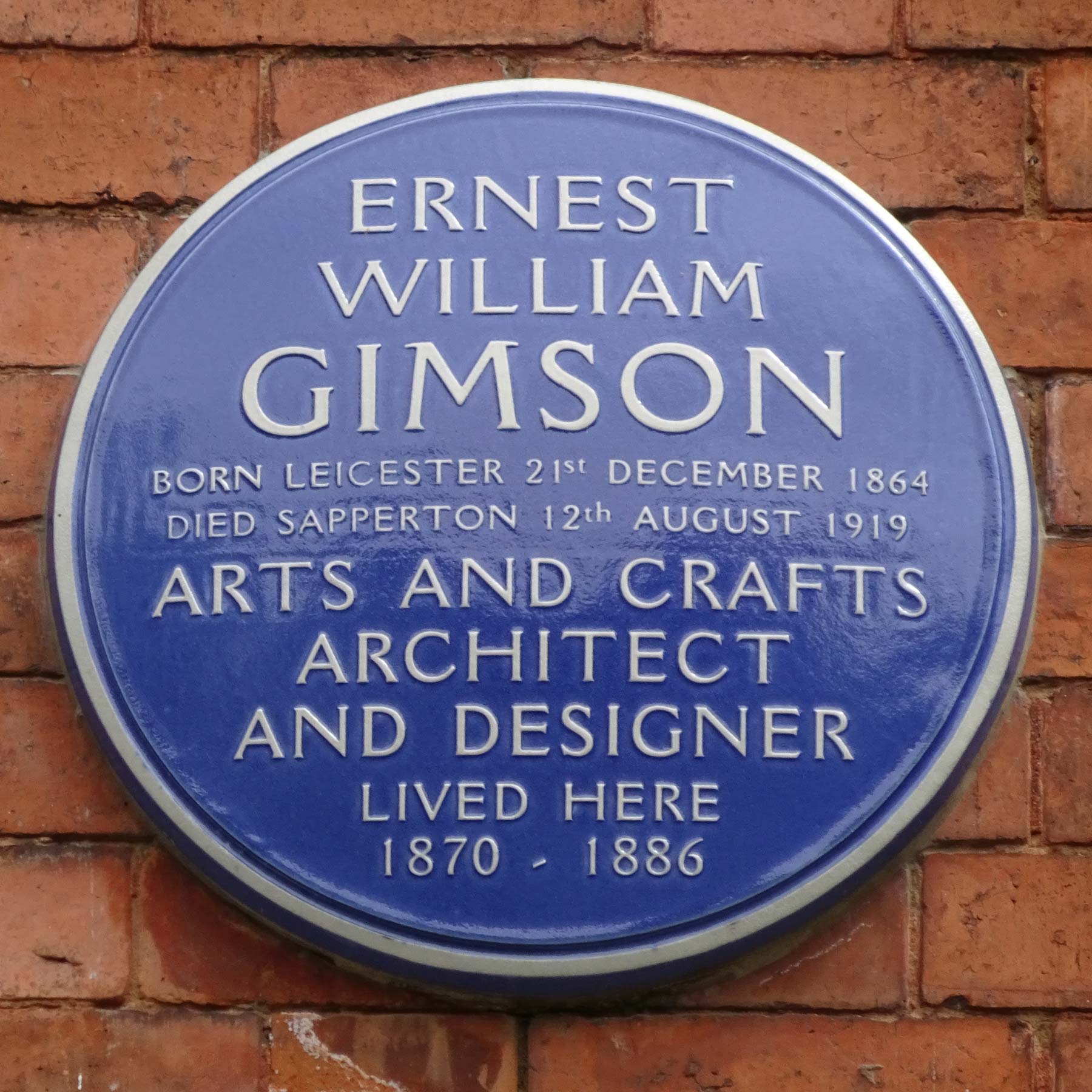 Blue round plaque with some brief details about Ernst William Gimson